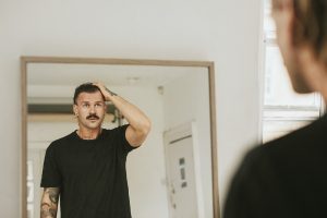 92f5c5b61457fe657bb684cf447413c5-man-with-mustache-looks-in-mirror